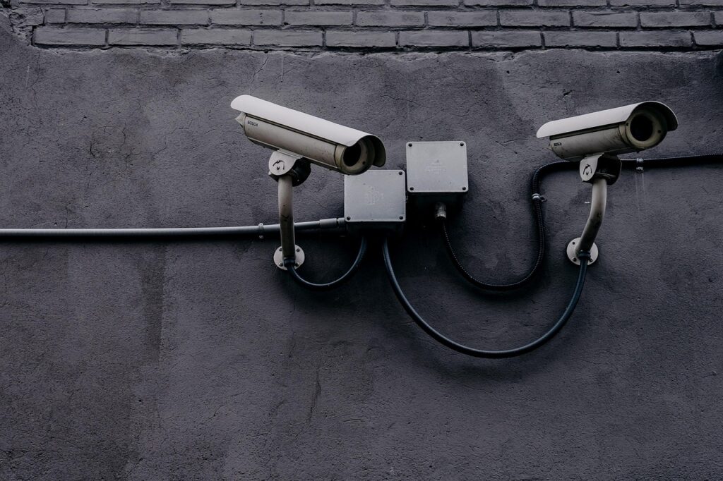 Security cameras attached to a gray wall